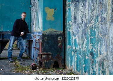 Portrait Of Young Man Stand In Blue Wall Corner