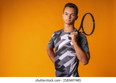 Portrait Of A Young Man Tennis Player On Orange Background