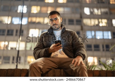 Portrait of young man using smart phone outdoors