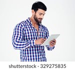 Portrait of a young man using tablet computer isolated on a white background