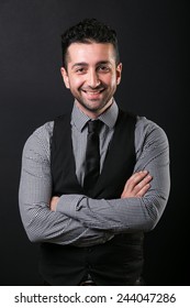 Portrait Of Young Man Wearing Shirt On Black Plain Background