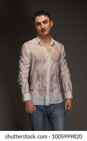 Portrait Of A Young Man In Wet Jeans And A White Shirt