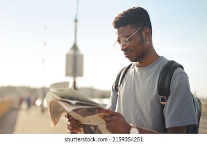 portrait of young man while reading a newspaper