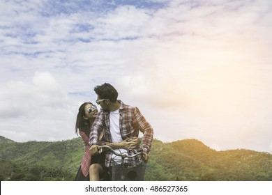 Portrait Of A Young Man And Woman Couple Tease And Having Fun At Mountain, Enjoy Holiday, Happy Life.