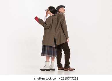 Portrait Of Young Man And Woman Wearing The Same Jacket Isolated Over White Studio Background. Concept Of Retro Fashion, Style, Friendship, Creativity, Youth Culture, Emotions, Ad