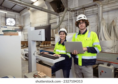 portrait young man and women engineer worker team work service support together in industry technology production machine plywood furniture factory