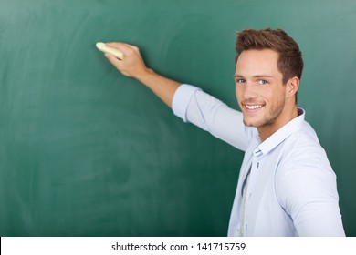 Portrait Of A Young Man Writing On Chalkboard