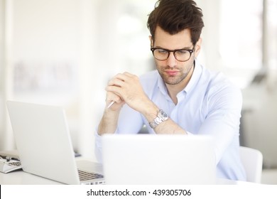 Portrait Of Young Marketing Director Businessman Working Online On Laptop.