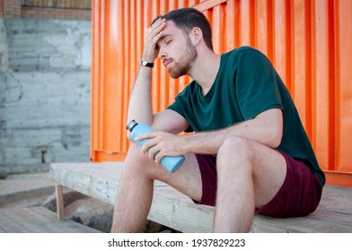 Portrait Of A Young And Masculine Man Drinking A Water Outside After Train At Gym. Relax After Running.  