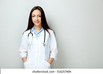 Portrait Of Young Medical Doctor On A Grey Background