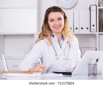 Portrait Of Young Medical Worker In Medical Center Sitting At The Table

