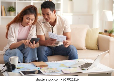 Portrait Of Young Modern Couple Planning Finances For Summer Vacation