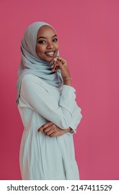 Portrait Of Young Modern Muslim Beauty Wearing Traditional Islamic Clothes On Plastic Pink Background. Selective Focus 