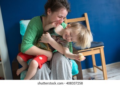 Portrait Of  Young Mother With Her Baby At Home, Living A Real Interior , Mom And Son Embrace