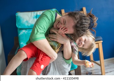 Portrait Of  Young Mother With Her Baby At Home, Living A Real Interior , Mom And Son Embrace