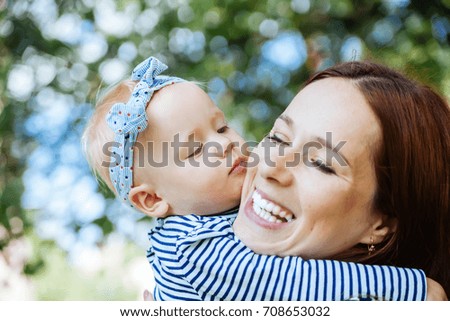 portrait of   young mother with   little daughter in her arms.