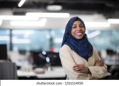 Portrait Of Young Muslim African American Female Software Developer With Blue Scarf Standing At Modern Startup Office