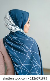 Portrait Of A Young Muslim Malay Woman In A Hijab (tudong, Head Scarf) Posing Against A White Background. 