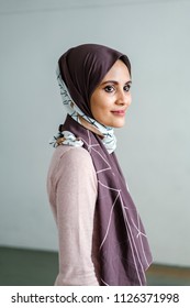 Portrait Of A Young Muslim Malay Woman In A Hijab (tudong, Head Scarf) Posing Against A White Background. 