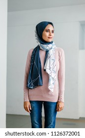 Portrait Of A Young Muslim Malay Woman In A Hijab (tudong, Head Scarf) Posing Against A White Background. 