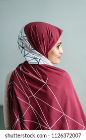 Portrait Of A Young Muslim Malay Woman In A Hijab (tudong, Head Scarf) Posing Against A White Background. 