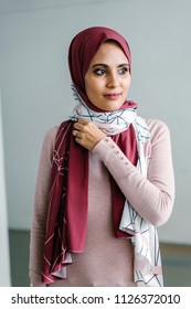 Portrait Of A Young Muslim Malay Woman In A Hijab (tudong, Head Scarf) Posing Against A White Background. 