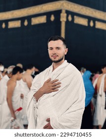 A portrait of a young Muslim man front of Kaaba in Mecca. 
