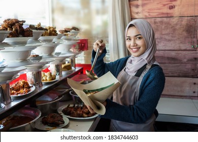 Portrait Of Young Muslim Woman Wrapping Padang Food