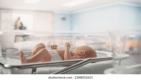 Portrait of a Young Newborn Baby Lying in a Bassinet in a Maternity Ward After Birth. Cute Neonate Child Calling for Mother, Feeling Energetic and Sleepless. Childbirth and Medical Clinic Concept