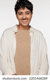 Portrait Of Young Non-binary Punjabi Person Smiling And Posing Confidently On White Background