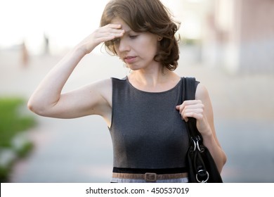 Portrait Of Young Office Woman Walking On The Street In Summer, Frowning, Holding Her Head With Hand, Businesswoman Has Forgotten Something Or Feeling Ill, Dizzy, Tired