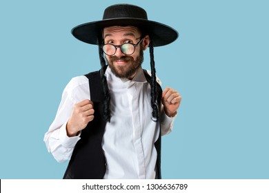 Portrait Of A Young Orthodox Jewish Man During Festival Purim. Holiday, Celebration, Judaism, Religion Concept. Human Emotions