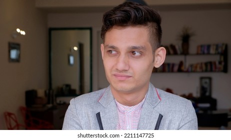 A Portrait Of A Young Pensive Indian Male Wearing A Trendy Jacket At Home