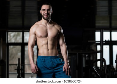 Portrait Of A Young Physically Fit Nerd Man Showing His Well Trained Body - Muscular Athletic Bodybuilder Fitness Model Posing After Exercises - Powered by Shutterstock