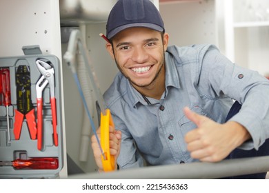 Portrait Of Young Plumber Holding Hacksaw