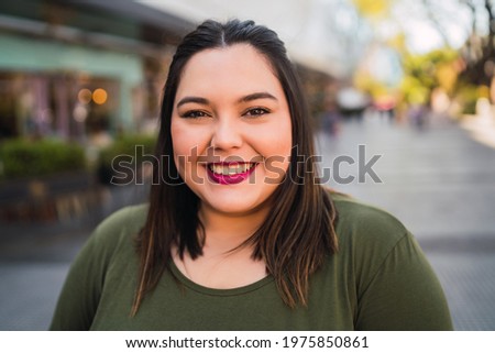 Similar – Close portrait of a young smiling woman with dimples in front of a white wall