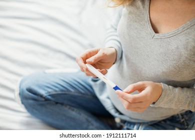 Portrait Of Young Pregnant Woman Holding Pregnantcy Test.