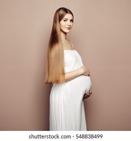Portrait of the young pregnant woman. Pregnancy, love, people and expectation concept. Happy pregnant lady with long hair