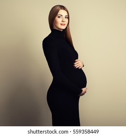 Portrait of the young pregnant woman. Pregnancy, love, people and expectation concept. Happy pregnant lady with long hair