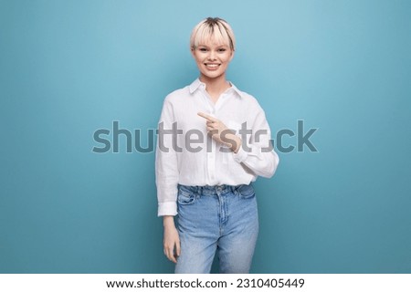 portrait of a young pretty blond secretary woman dressed in a white blouse on a blue background with copy space