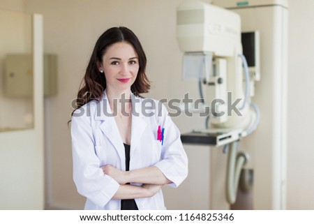 Portrait of the young pretty breast specialist who is standing in her office