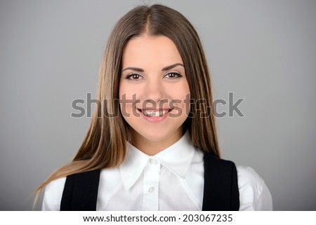 Portrait of young pretty emotional woman on gray background