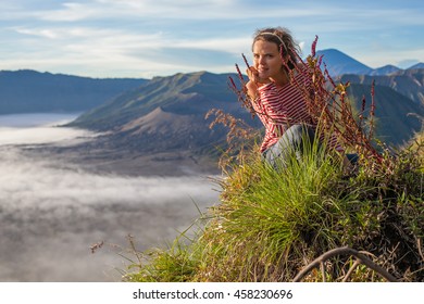 Portrait Young Pretty Girl Sunrise Landscape.Africa Nature Morning Volcano Viewpoint.Woman Engaged Yoga Meditation Practice Mountains Dawn.Mountain Trekking.Horizontal picture.First Rays Rising Sun - Powered by Shutterstock