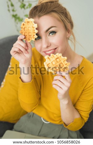 Portrait of young pretty woman with a cookies by the hands