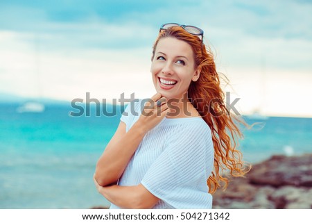 Portrait of young pretty woman enjoying summer day on a beach with ocean sea background 