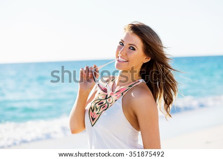 Portrait of young pretty woman on summer day on sandy beach