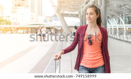 Portrait of young Russian girl, Young Russian girl in concept of tourism to Thailand, Young Russian girl at bridge link between mrt and bts mass transportation in bangkok city, Bangkok, Thailand.