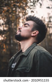 A Portrait Of A Young Russian Man With A Beard And A Stylish Hairstyle In A Forest