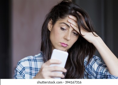 Portrait Of Young Sad Annoyed Woman, Receiving Bad Sms