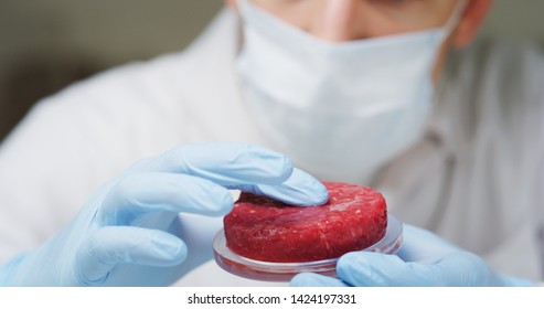 Portrait of an young scientist is inspecting and analyzing the cultured artificial meat sample in laboratory.